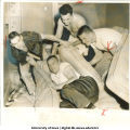 Football player Dick Klein dumped off his mattress by teammates between Rose Bowl practice sessions, Pasadena, Calif., December 22, 1956