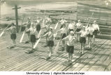 Land drill demonstrating changing paddles tandem bow, The University of Iowa, 1930s