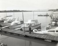 Man stands on dock by boats
