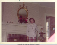 Frindy standing at the fire place in living room 