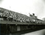 Fans in the stands at Clyde Williams Field and security at Homecoming, 1959