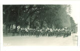 ROTC military band marching down a street, The University of Iowa, 1910s