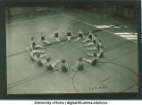 Synchronized swimmers practice on basketball court, The University of Iowa, 1930s