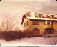 View of car parked in front of Grey house in Winter