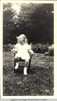 Vidie Burden sitting in chair in garden looking down