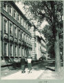 Students walking on the sidewalk along Capitol Street in front of Chemistry-Botany Building, The University of Iowa, 1950s
