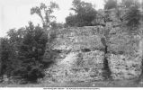 Sixty foot high bluff of Oneota (massive above) with cherty partings at base, Iowa, late 1890s or early 1900s