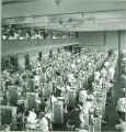 Dental students working on patients in a clinic, The University of Iowa, June 1953