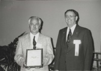 Robert Schultze (left) receives Iowa Conservation Secondary Teacher of the Year Award.