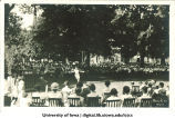 Woman dancing in front of a large audience on the Pentacrest at a June celebration, The University of Iowa, 1920