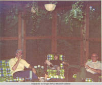 Bill smoking cigarette, John, Jr. and unknown man relaxing in screened in porch