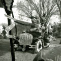 Phi Delta Theta homecoming lawn display of Disney characters and Cy riding a jalopy in Victoryland, 1961