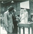 Instructor inspecting student's sculpture, The University of Iowa, 1940s