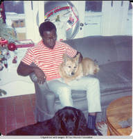 Ainsley Benard sitting on couch with Victoria in his lap and Sadie at his feet at White house