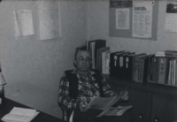 Harold Brown reading in the office.