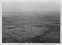 Aerial view of contoured farmland with roads, farms, and trees