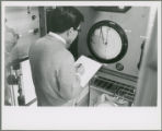 Researcher checks a circular gauge