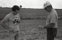1978 Two men look at pipe