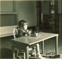 Girl playing at table, The University of Iowa, January 12, 1938