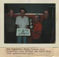 Commissioners presenting Wayne Dankert, Soil Scientist, with a cake and gift of appreciation.