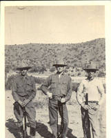 Men standing with rifles