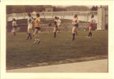 Scottish Highlander dancers practicing by Iowa River near pedestrian footbridge, The University of Iowa, 1970s