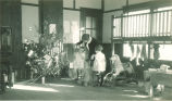 Children decorating a Christmas tree in a playroom, The University of Iowa, 1930s
