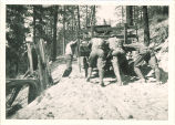 Pushing truck over mountains to Billy Goat Pass on scientific expedition, The University of Iowa, 1920