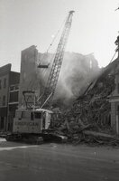 Crane demolishes building