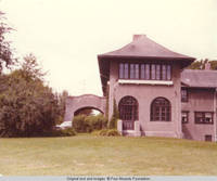 East view of Grey house and carport in Spring
