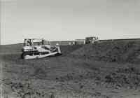 Bulldozer and Truck with people standing nearby