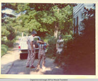 Bill, John, Jr. and unknown woman by truck 