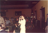 Woman taking picture at Scottish Highlander banquet, The University of Iowa, May 1978
