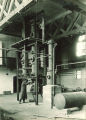 Man using large machine in a chemistry department machine shop, The University of Iowa, 1930s