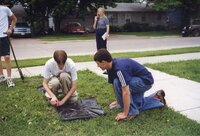1999 Students anchor the plastic on a newly planted tree