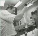 Researcher using pipette, 1978