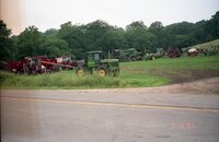 Tractors sit in fields near flooded areas