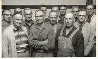 Thirteen Unidentified Smiling Men Pose for Photo