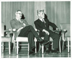 Philip D. Sang, right, listening to presentation about the Phliip D. Sang exhibition at University Library, The University of Iowa, 1956