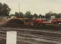 Red tractor and plow being driven at the Plymouth County Fair in July 1996.