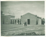 Couple on sidewalk next to the Art Building, The University of Iowa, 1930s