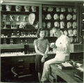 Dental student shows a girl some dentistry models, The University of Iowa, 1940s