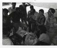 1970s Group looks at rolls in a HyVee Bakery box