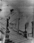 Foot of the Grand Staircase and light fixtures, circa 1885.