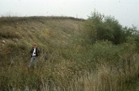 Man in eroded gully.