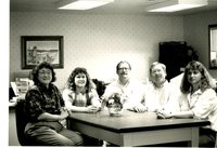 Five People Sitting Around Office Table