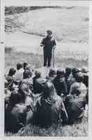 Conservationist Henry Tordoff gives a talk to students outside in a park
