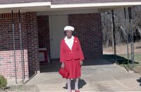 Unidentified family dressed up stands in front of brick building