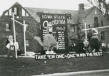 Homecoming lawn display, ""Take 'em one by one 'n win the rest,"" 1962