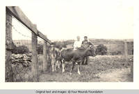 Sandy and Leo standing by cows